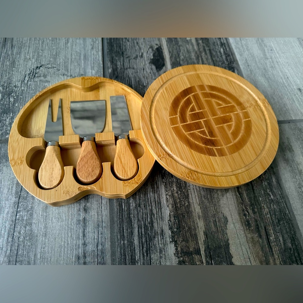 Cheese or charcuterie board with serving utensils inside mini portable Picnic